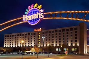 A large hotel with a prominent sign reading "Harriss" and a decorative archway with lights.
