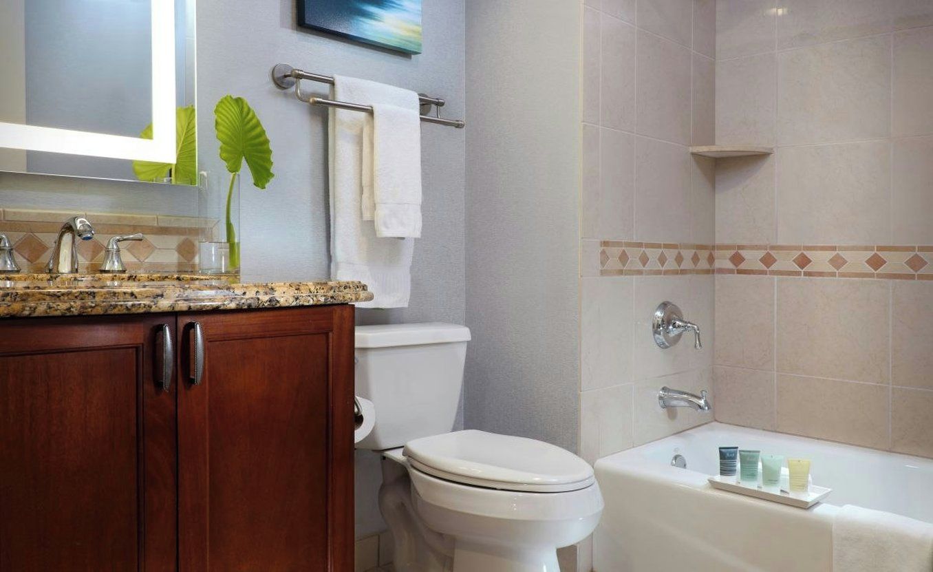 A bathroom with a toilet, sink, and bathtub.