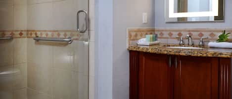 A bathroom with a shower, toilet, and sink.