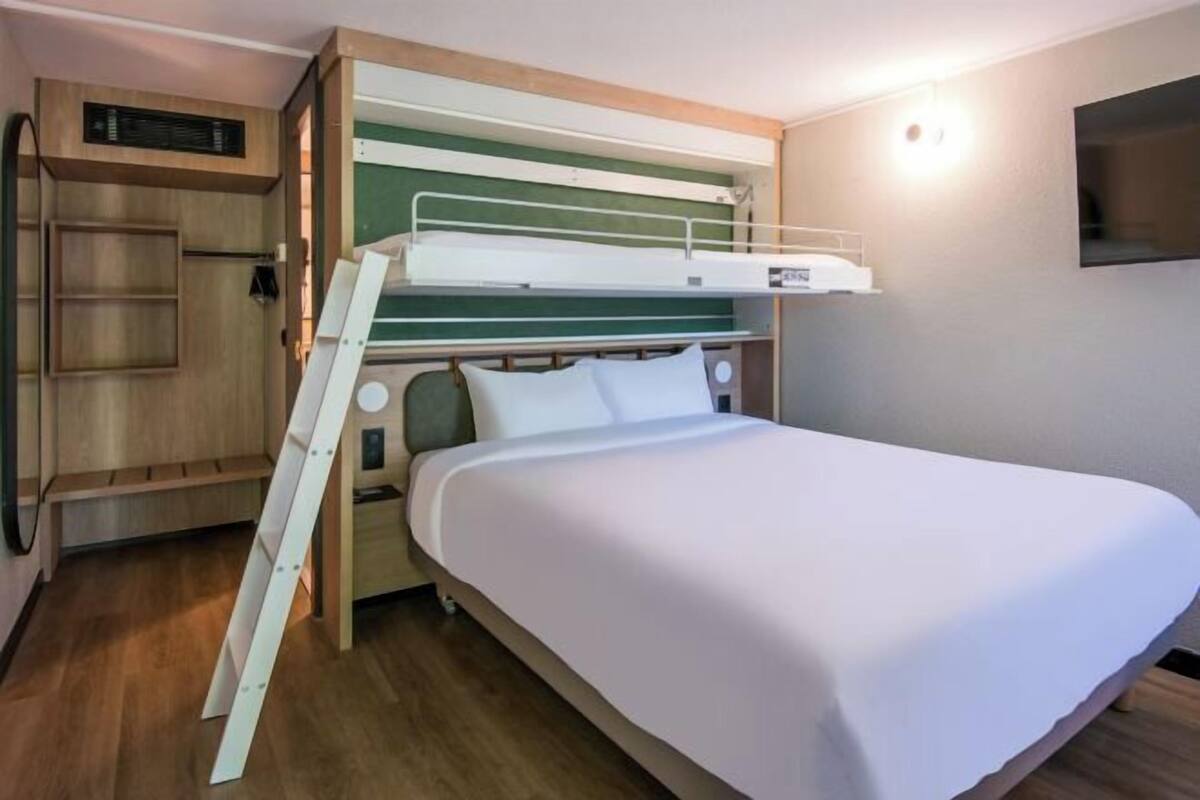 Premium bedding, desk, laptop workspace, blackout drapes
