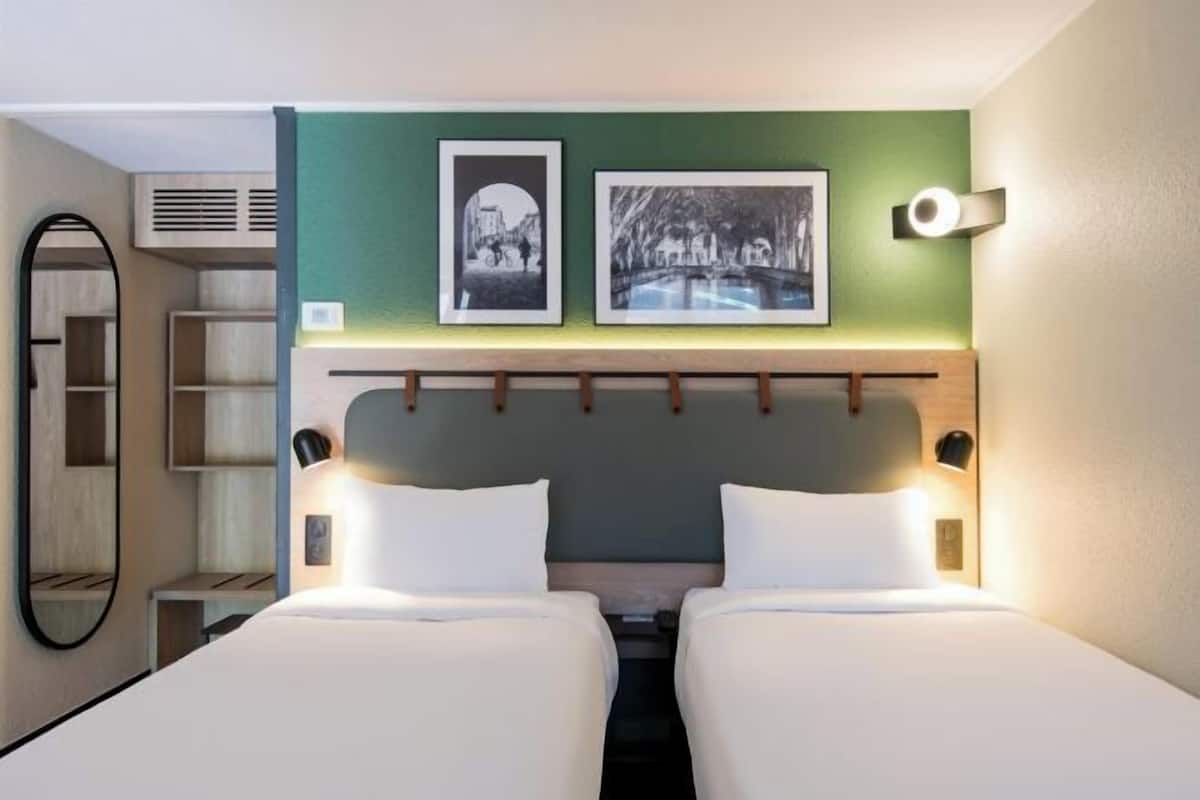 Premium bedding, desk, laptop workspace, blackout drapes