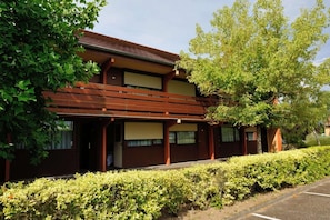A traditional Japanese-style building with a wooden exterior and a covered entrance. - Campanile NATURE - Moulins Avermes (Avermes)
