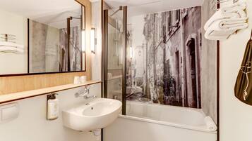 Bathtub, eco-friendly toiletries, hair dryer, towels