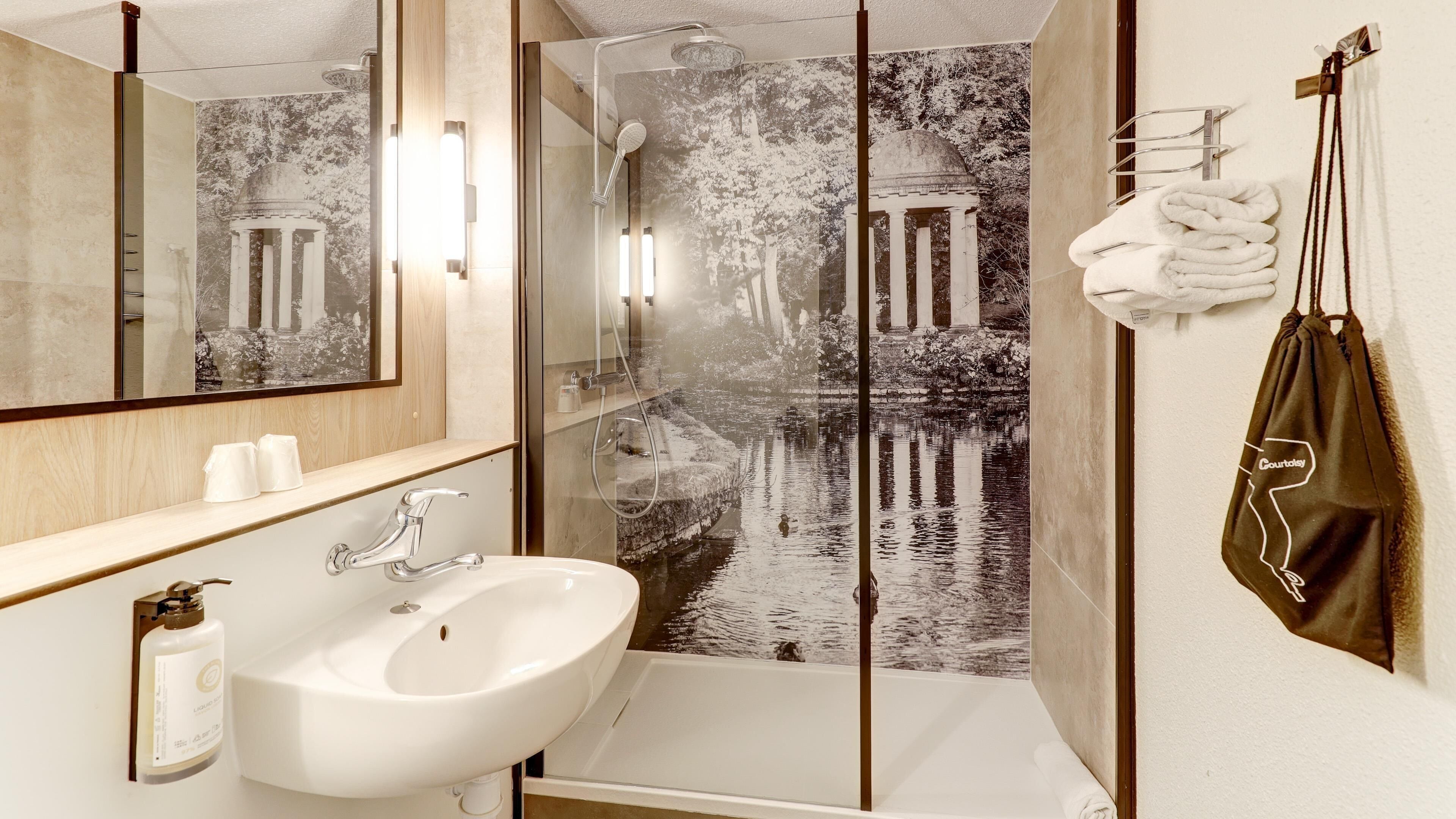 Bathtub, eco-friendly toiletries, hair dryer, towels