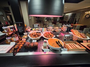 A breakfast buffet with various pastries, bread, and condiments. - Hotel Campanile Aurillac (Aurillac)