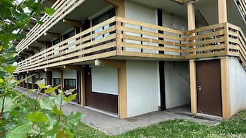 Stunning multi-story building with balconies and lush green surroundings.