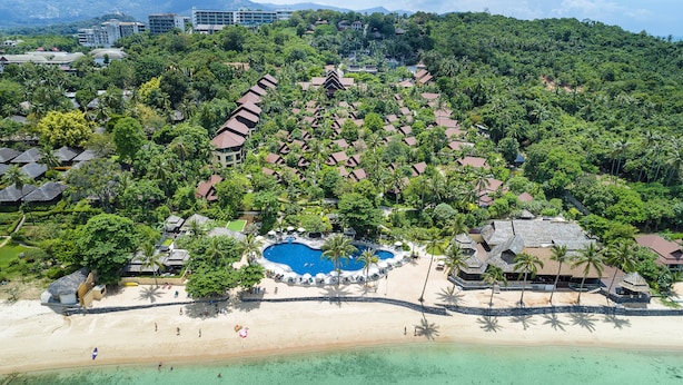 An aerial view of a resort with a central swimming pool, beachfront villas, and lush greenery. - Nora Beach Resort and Spa (Koh Samui)
