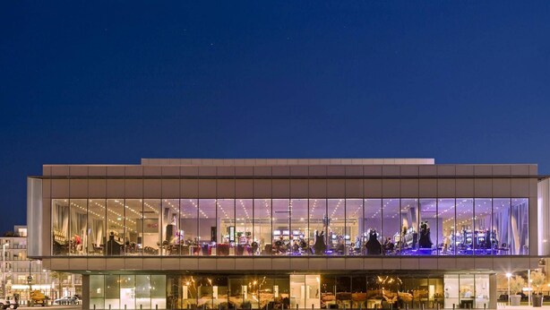 A modern building with a glass facade, multiple levels, and outdoor seating areas. - Grand Hôtel Dauphiné Toulon, Boutique Hôtel & Suites (Toulon)