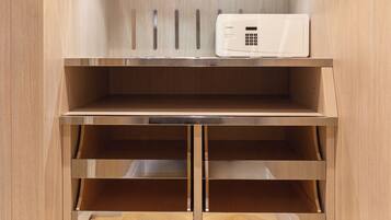 A wooden cabinet with multiple shelves and drawers, a microwave on the top shelf, and a light strip above the microwave.