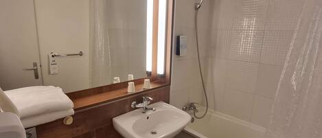 A bathroom with a sink, toilet, and shower.