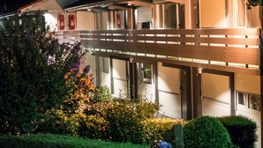A two-story building with a covered outdoor area, a red mailbox, and a well-maintained garden with various plants and flowers. - Campanile Villeneuve sur Lot - Pujols (Pujols)