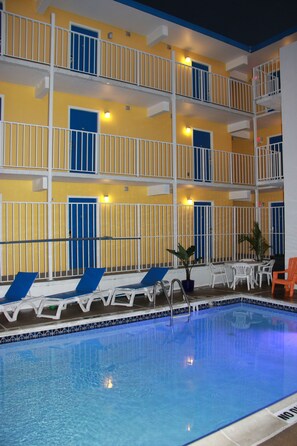 A multi-story hotel with a pool area.