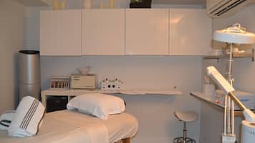 Cozy retreat with a neatly made bed, bedside table, and comfortable chair.