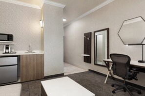A modern bathroom with a sink, mirror, and a shower area. - Holiday Inn Express and Suites Bakersfield Central by IHG (Bakersfield)
