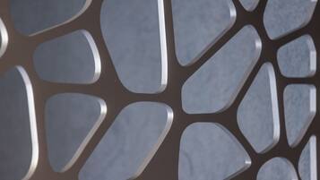 A close-up of a metallic, geometric pattern with interlocking shapes.