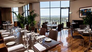 Enjoy meals in this elegant dining area with a long table and comfortable seating for all.