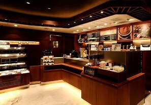 A coffee shop interior with a counter, coffee machines, and a menu board. - Sotetsu Fresa Inn Tokyo-Akasaka (Tokyo)