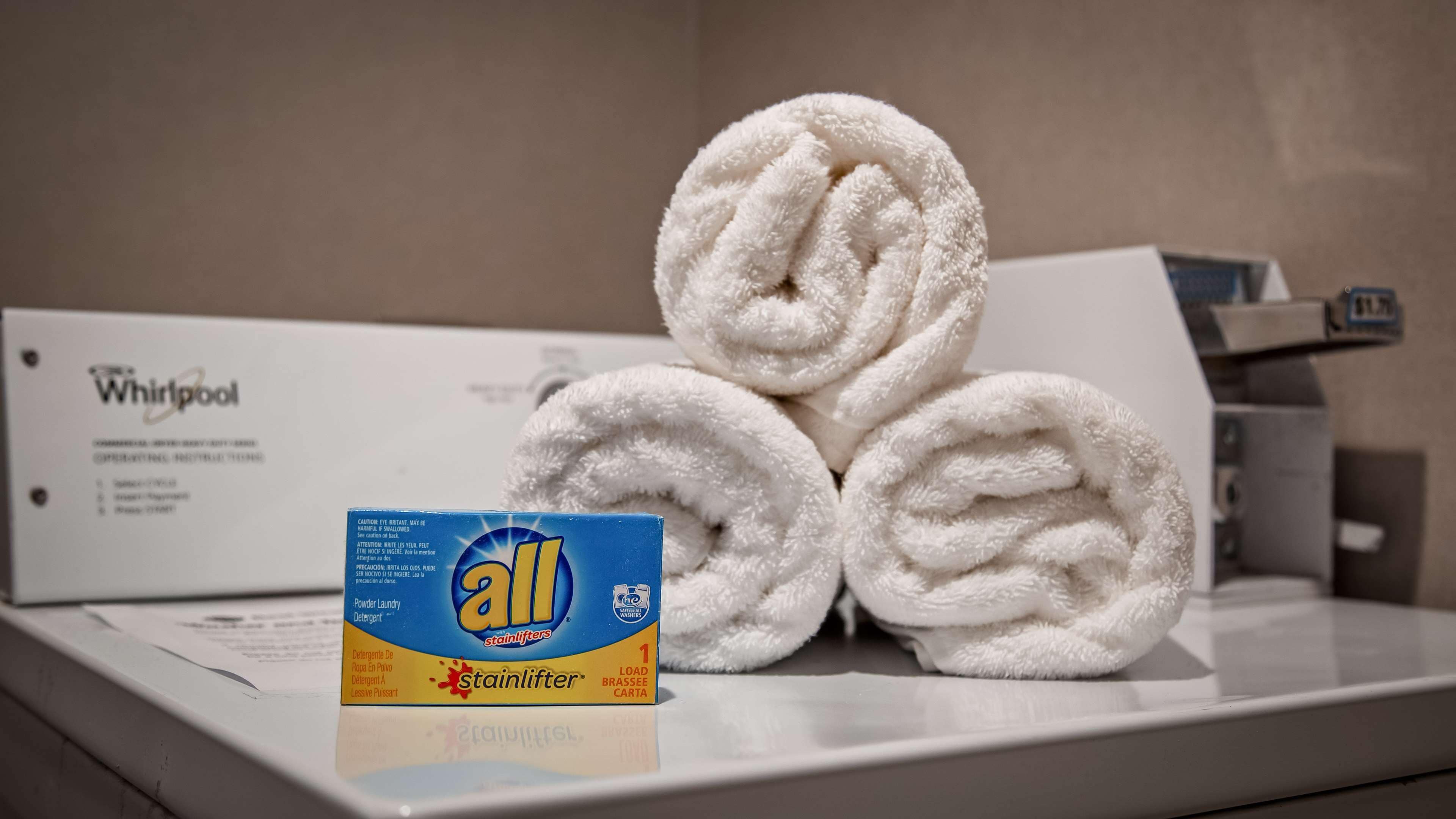 A Whirlpool branded box and a bottle of All stain lifters detergent on a counter.