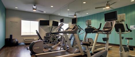 A fitness center with treadmills, elliptical machines, and exercise bikes.