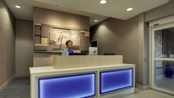 Una recepción de hotel con diseño moderno, una pantalla digital y puerta de entrada de vidrio.