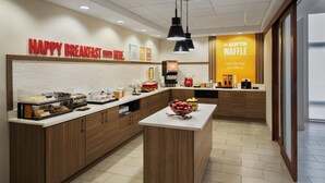 A breakfast area with a sign reading 'HAPPY BREAKFAST STARTS HERE.'
