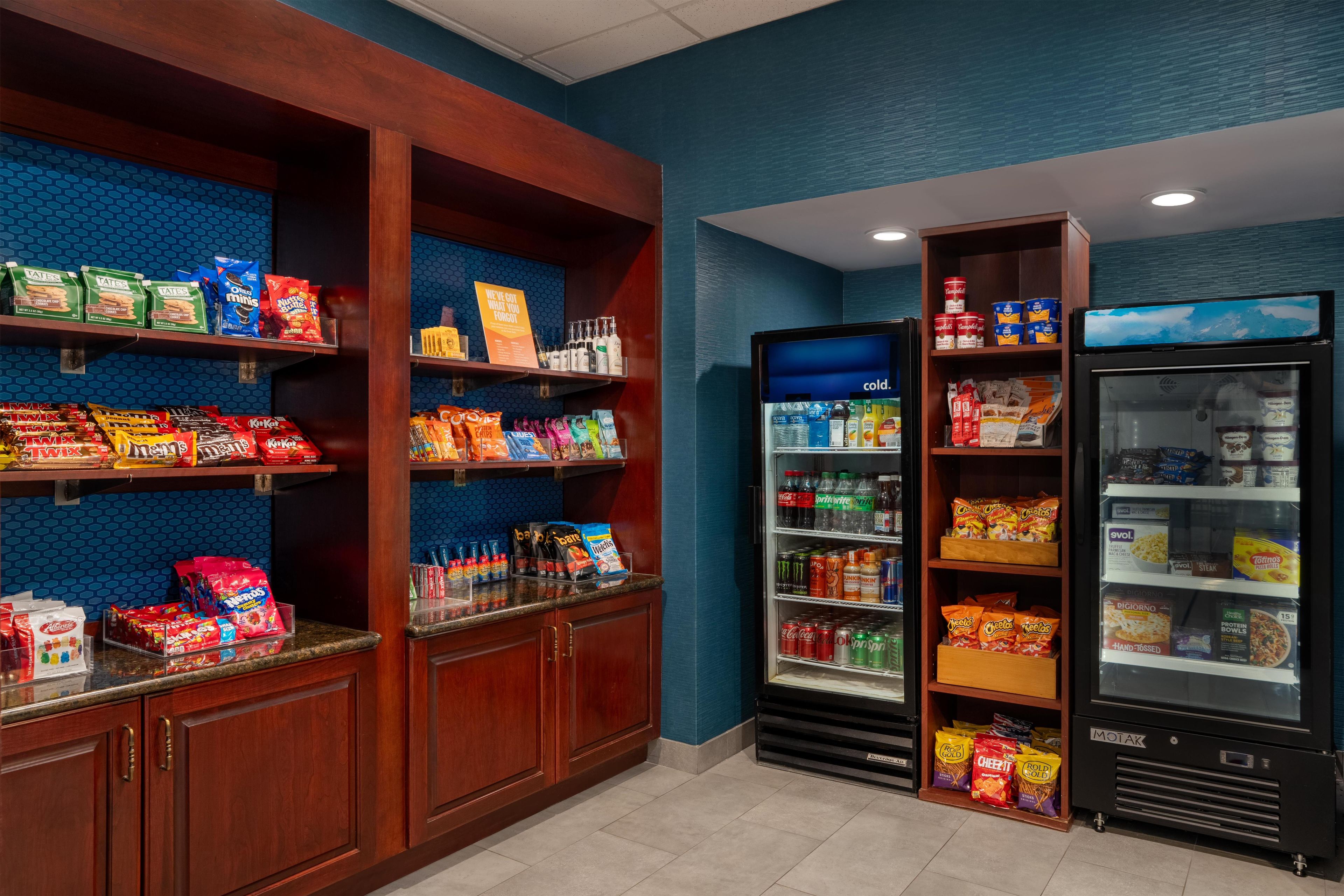 A snack and beverage vending area with various brands of chips, snacks, and drinks.