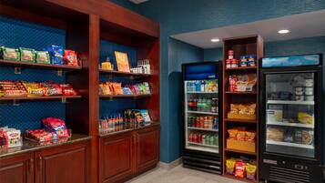 A snack and beverage vending area with various brands of chips, snacks, and drinks.
