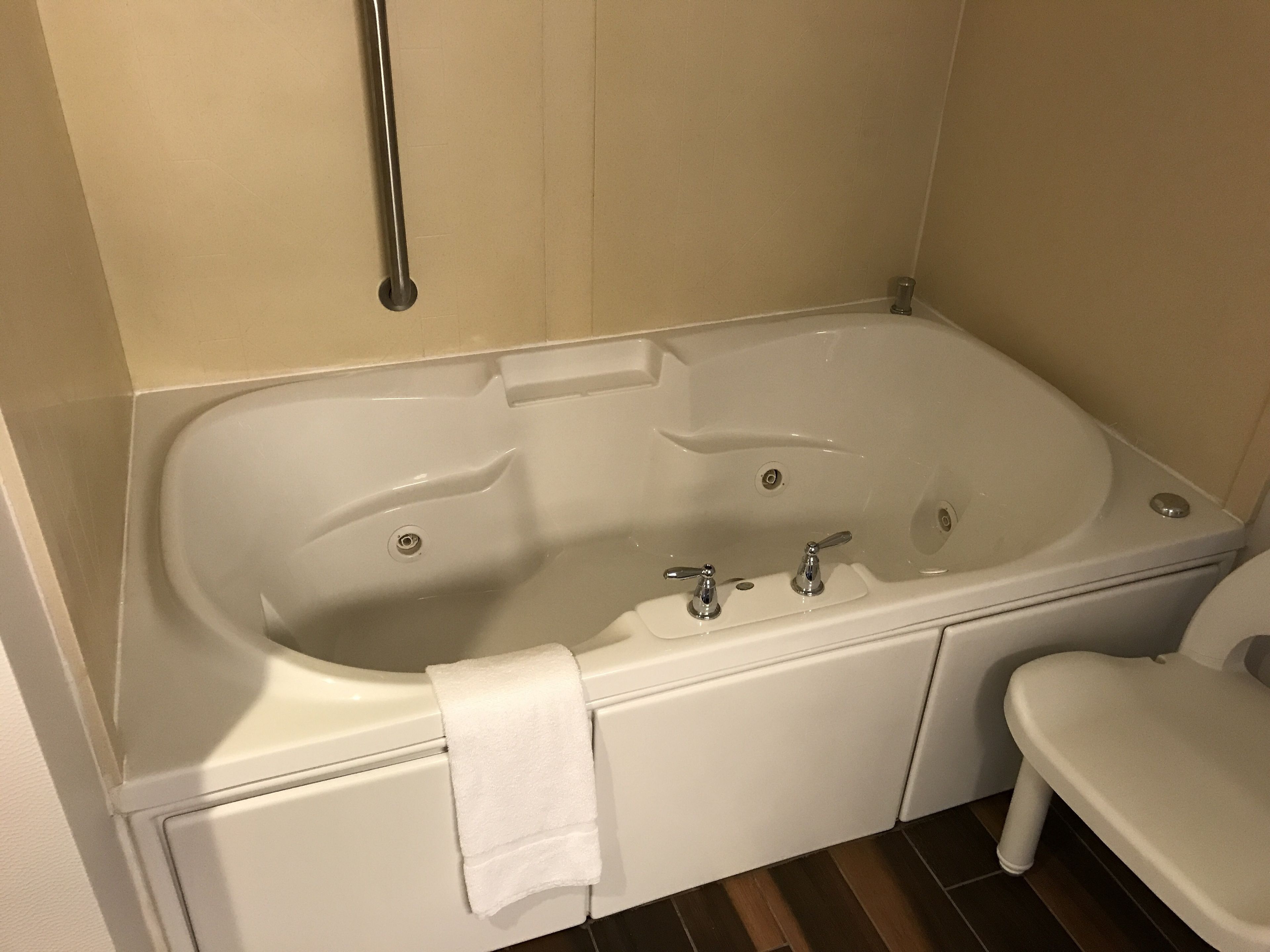 A standard bathroom with a bathtub, a toilet, and a shower area.