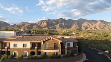 A hotel with a courtyard and mountain views.
