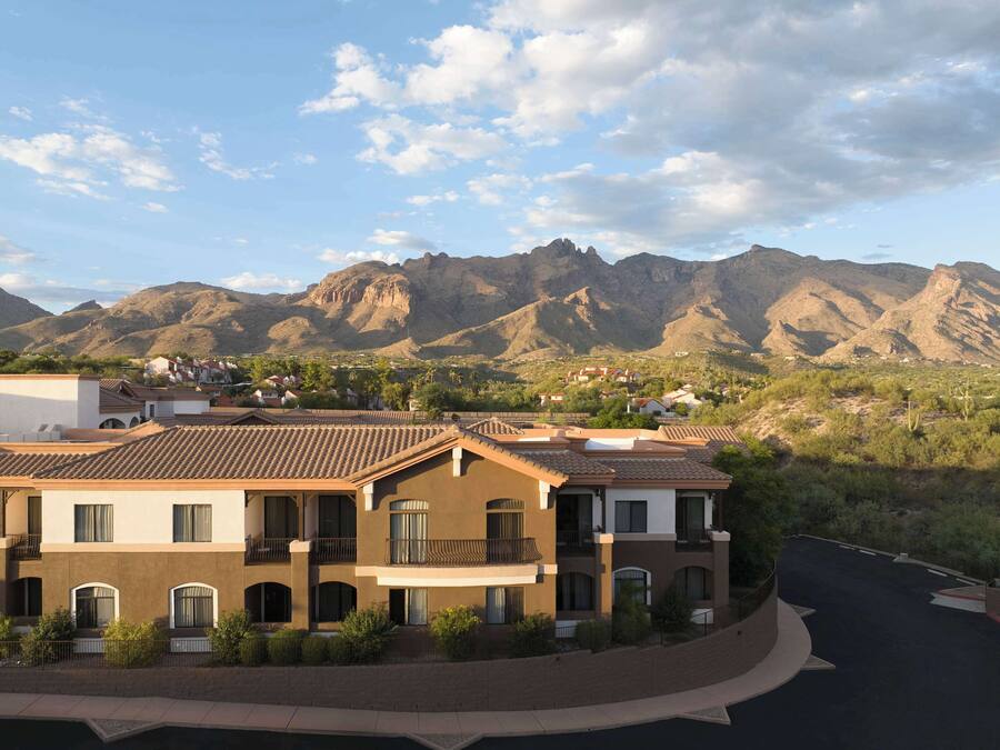 A hotel with a courtyard and mountain views.