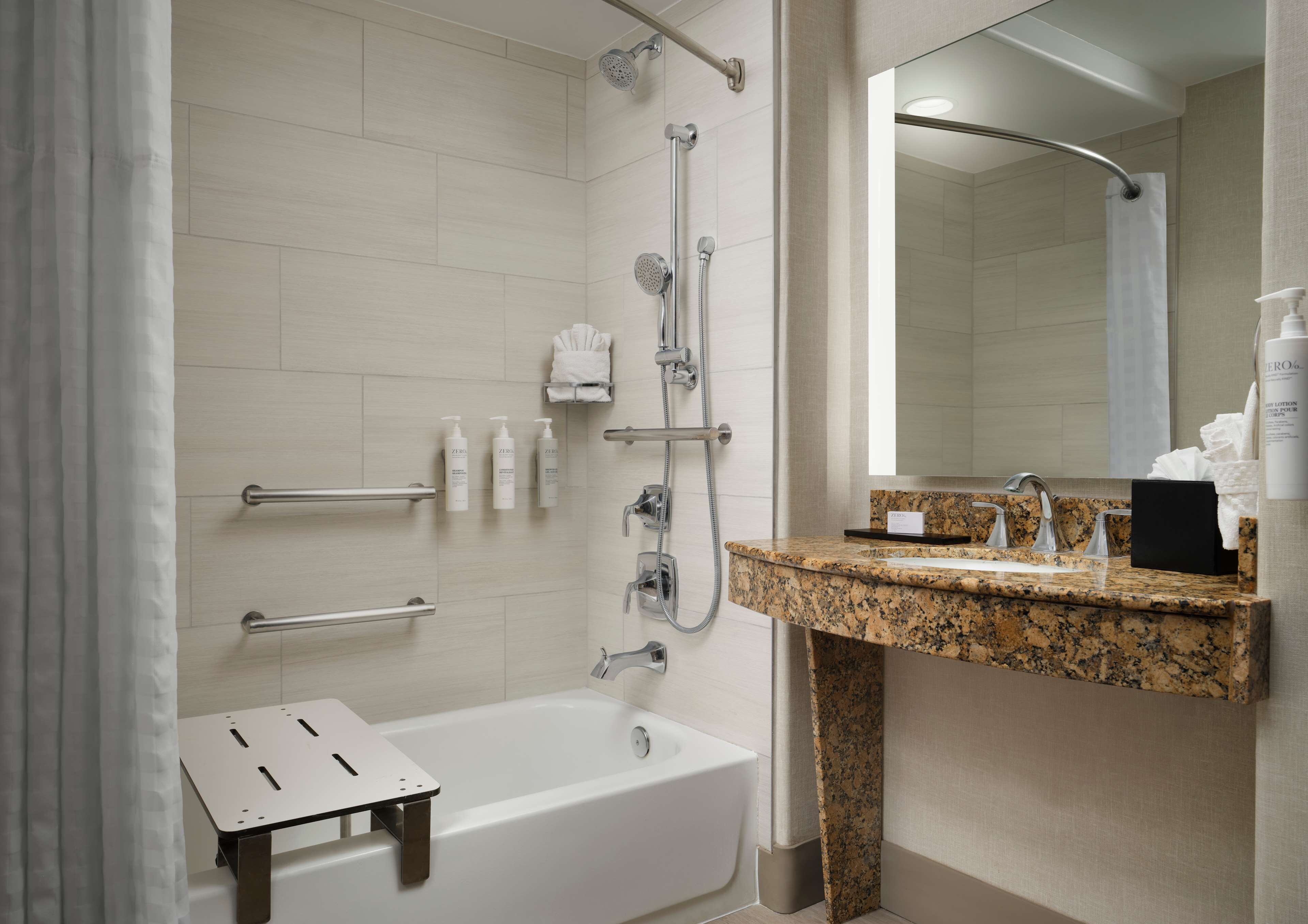 combined shower/bathtub, designer toiletries, hair dryer, towels