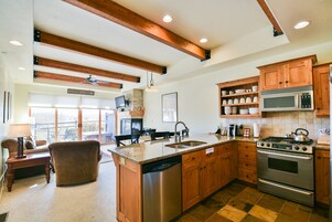 A kitchen with wooden cabinets, a dishwasher, a stove, and a microwave.