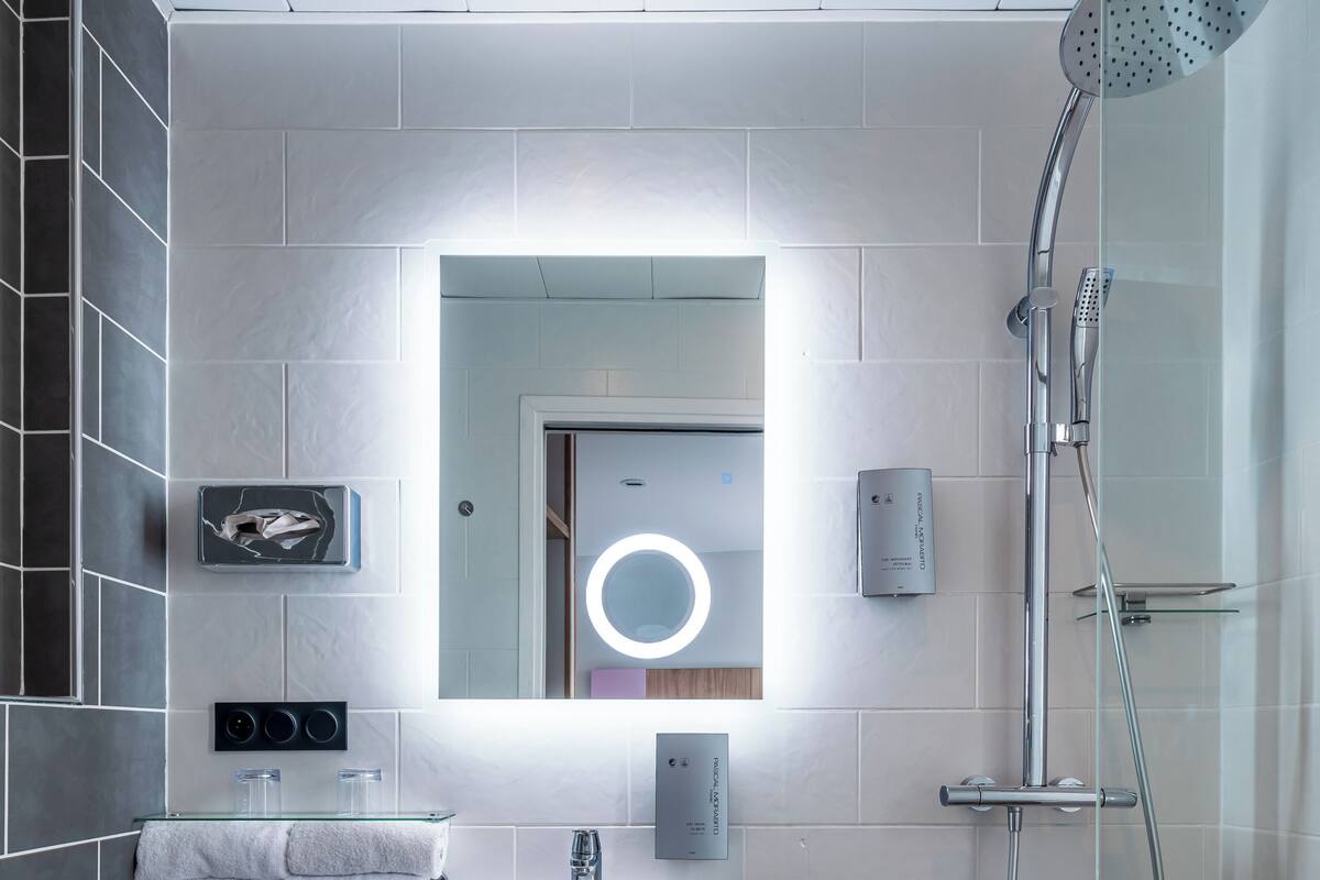 A modern bathroom with a toilet, sink, and shower.