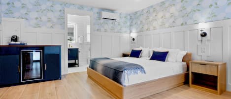 A bedroom with a bed, bedside tables, a wardrobe, and a built-in desk with a chair.