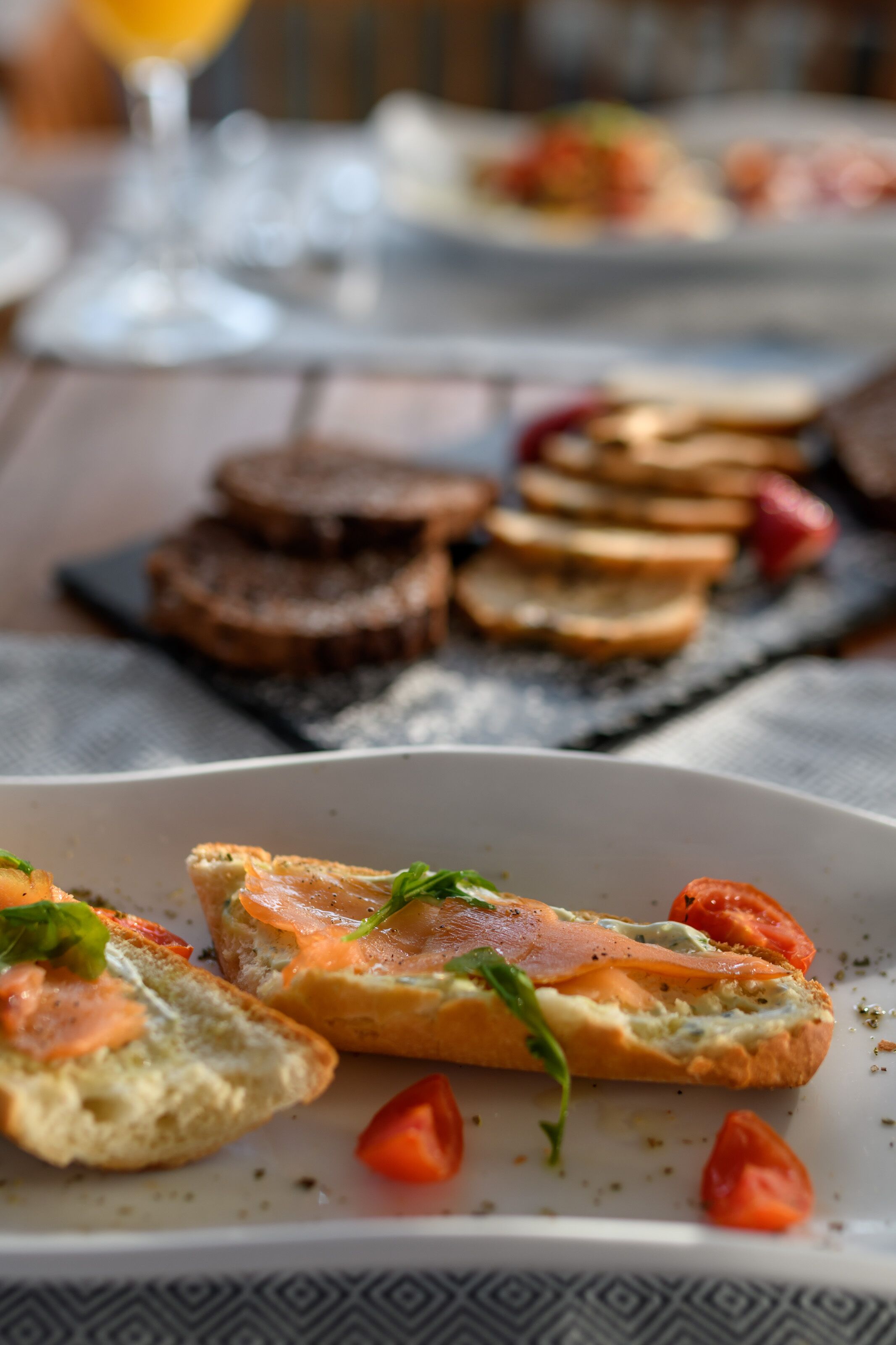 Ein Tisch mit verschiedenen Speisen, darunter Brot mit Belägen und ein Glas Orangensaft.