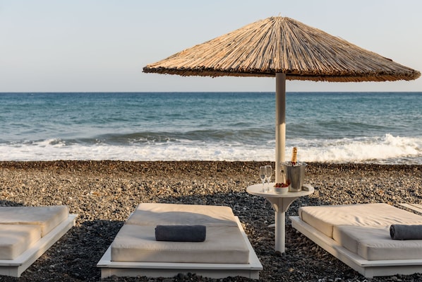Private beach, black sand, sun-loungers, beach umbrellas