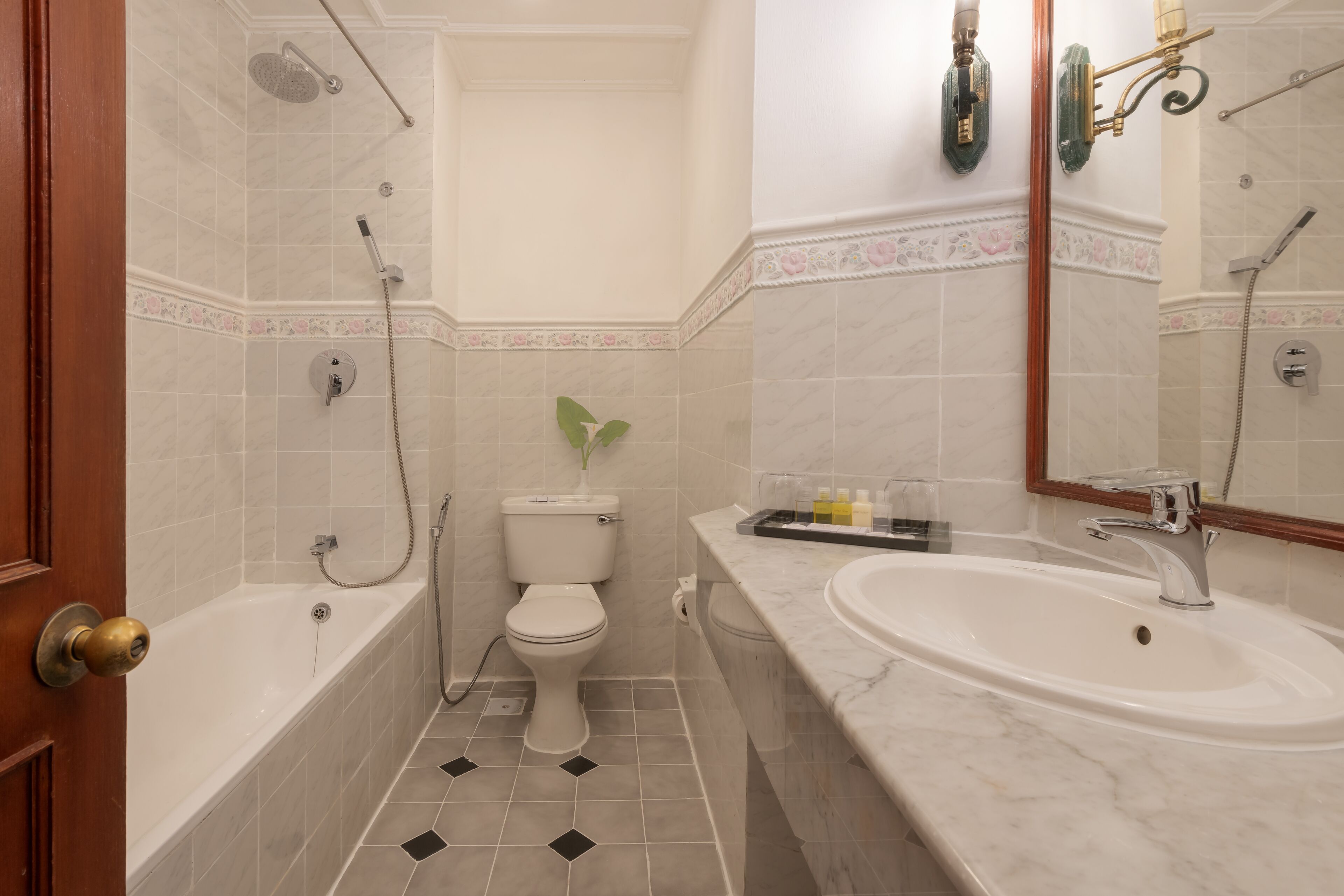 A bathroom with a bathtub, toilet, and sink.
