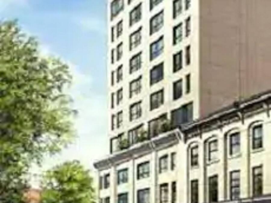 A multi-story building with a modern architectural design, featuring a mix of rectangular and square windows.