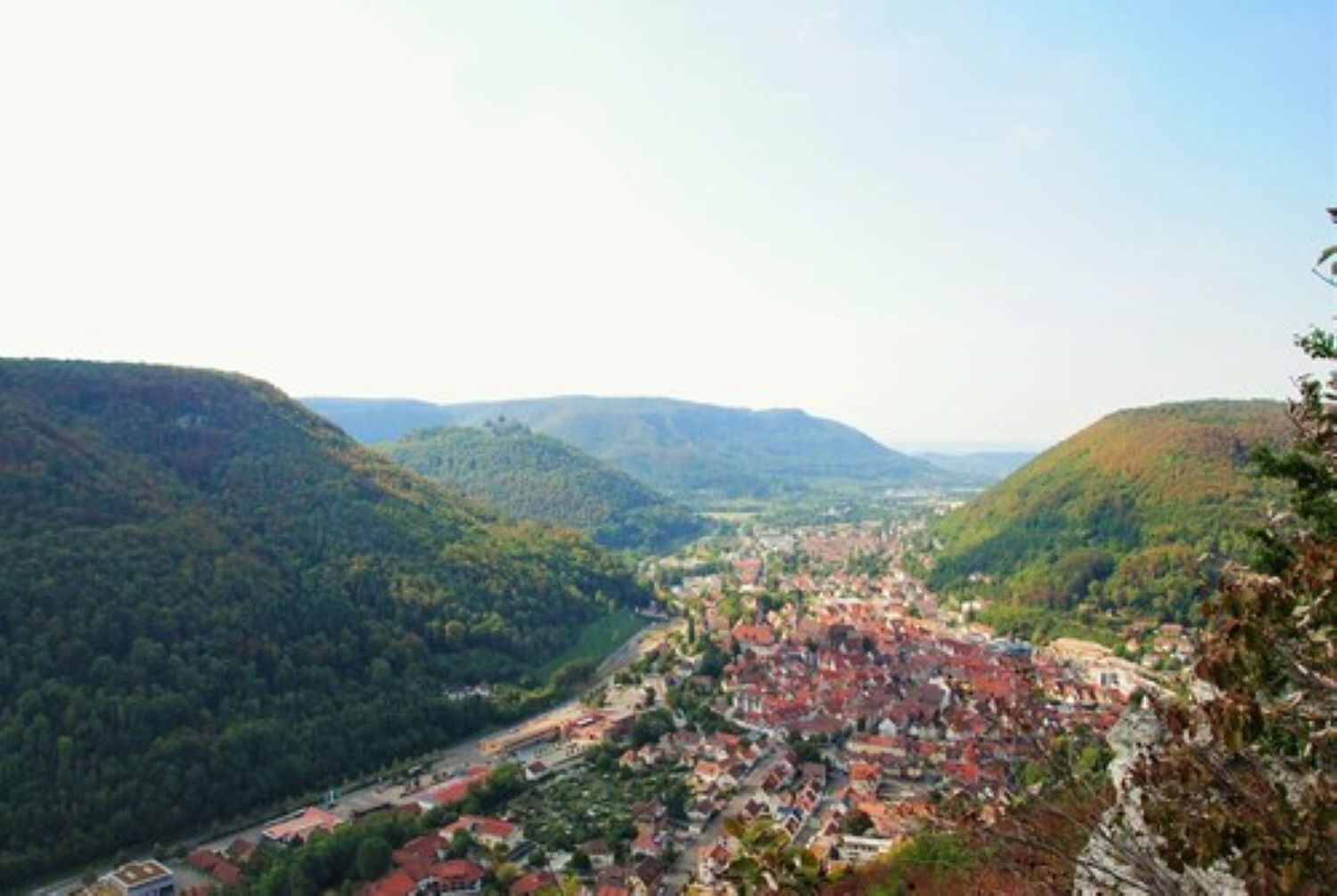 A town nestled in a valley surrounded by hills.