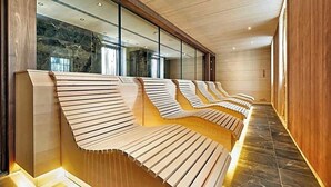 A row of wooden benches with a unique slatted design, positioned against a wall with a glass window. - The Cloud One Dresden-Frauenkirche (Dresden)