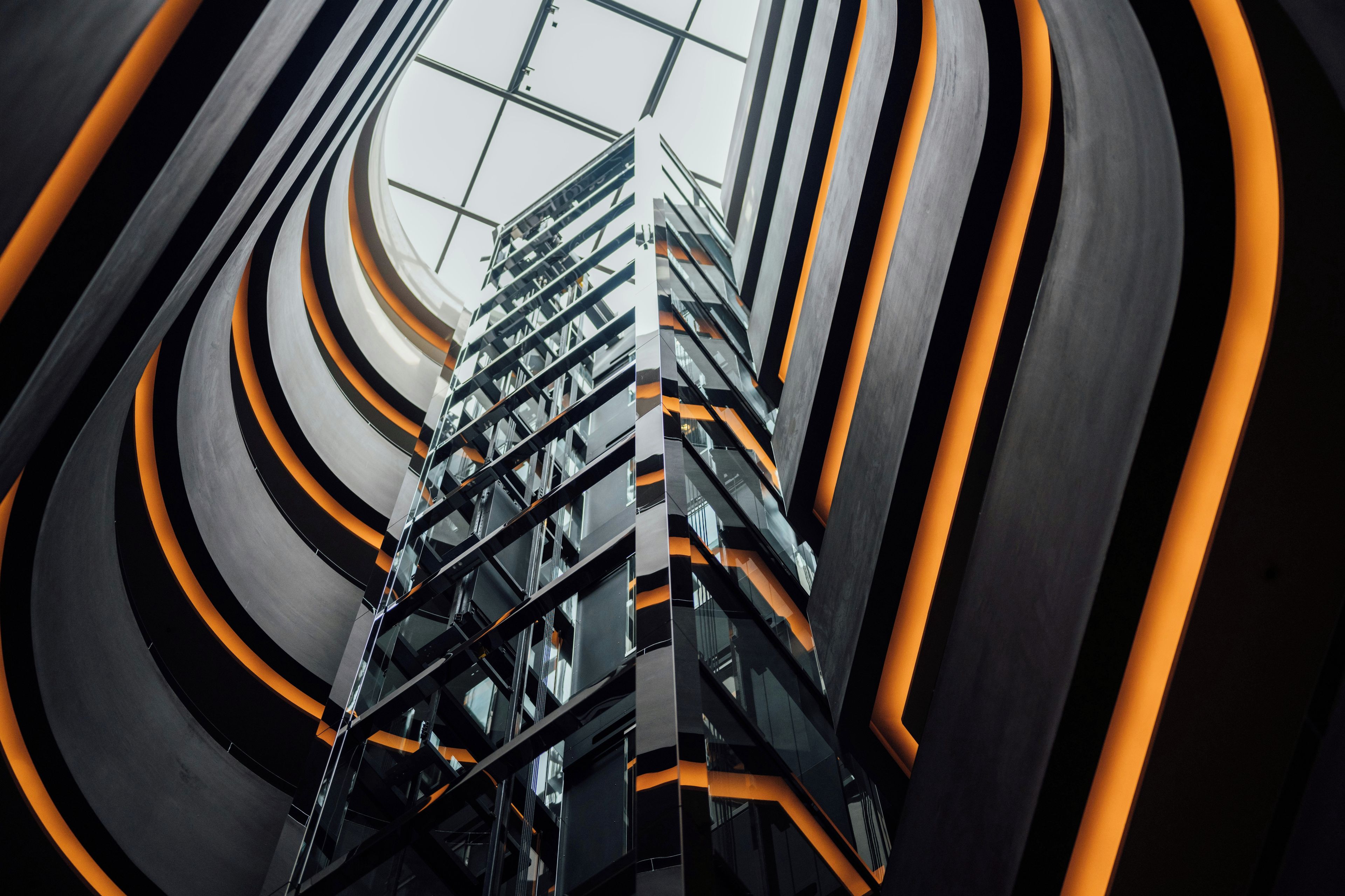 A modern building with a spiral staircase and a glass ceiling.
