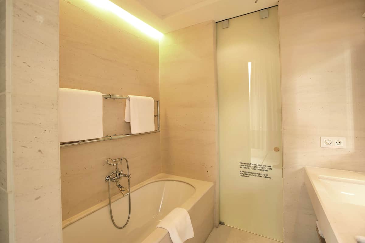 deep-soaking bathtub, rainfall showerhead, free toiletries, hair dryer