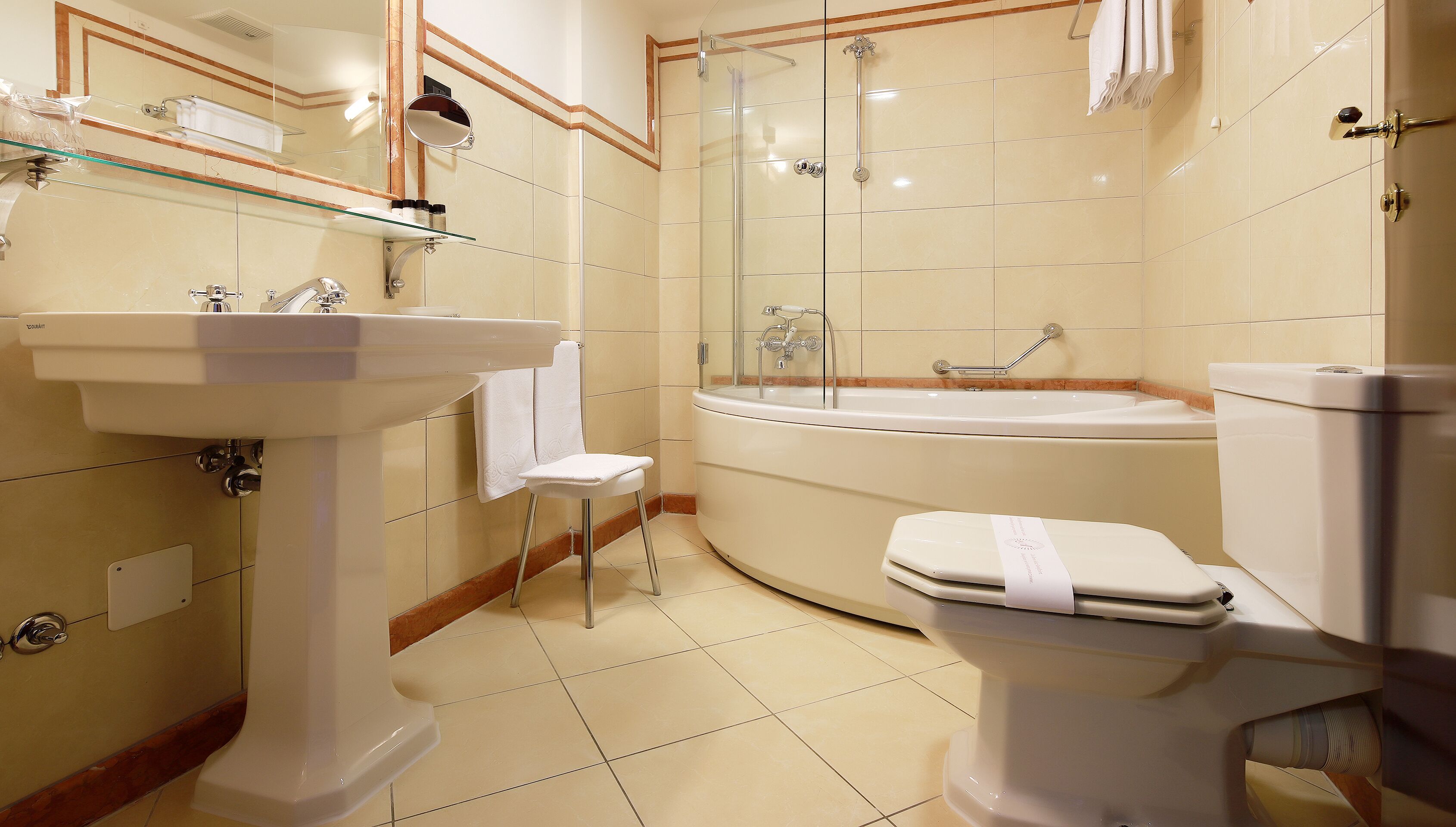 A modern bathroom with a sink, toilet, and bathtub.