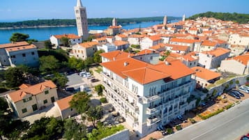 Stroll through historic streets lined with traditional and modern architecture, featuring a prominent church with a tall bell tower.