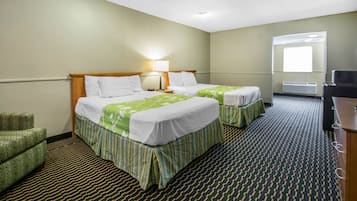 A hotel room with two beds, a chair, a desk, and a large window.