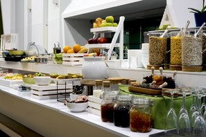 A buffet with various food items and beverages. - Atrium Hotel by Mellow Mood Hotels (Budapest)
