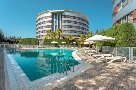 Seasonal outdoor pool, open 11:00 AM to 9:00 PM, pool umbrellas