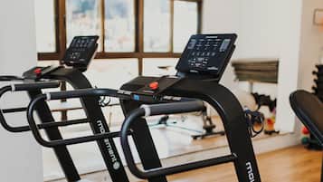 A gym with treadmills and exercise equipment.