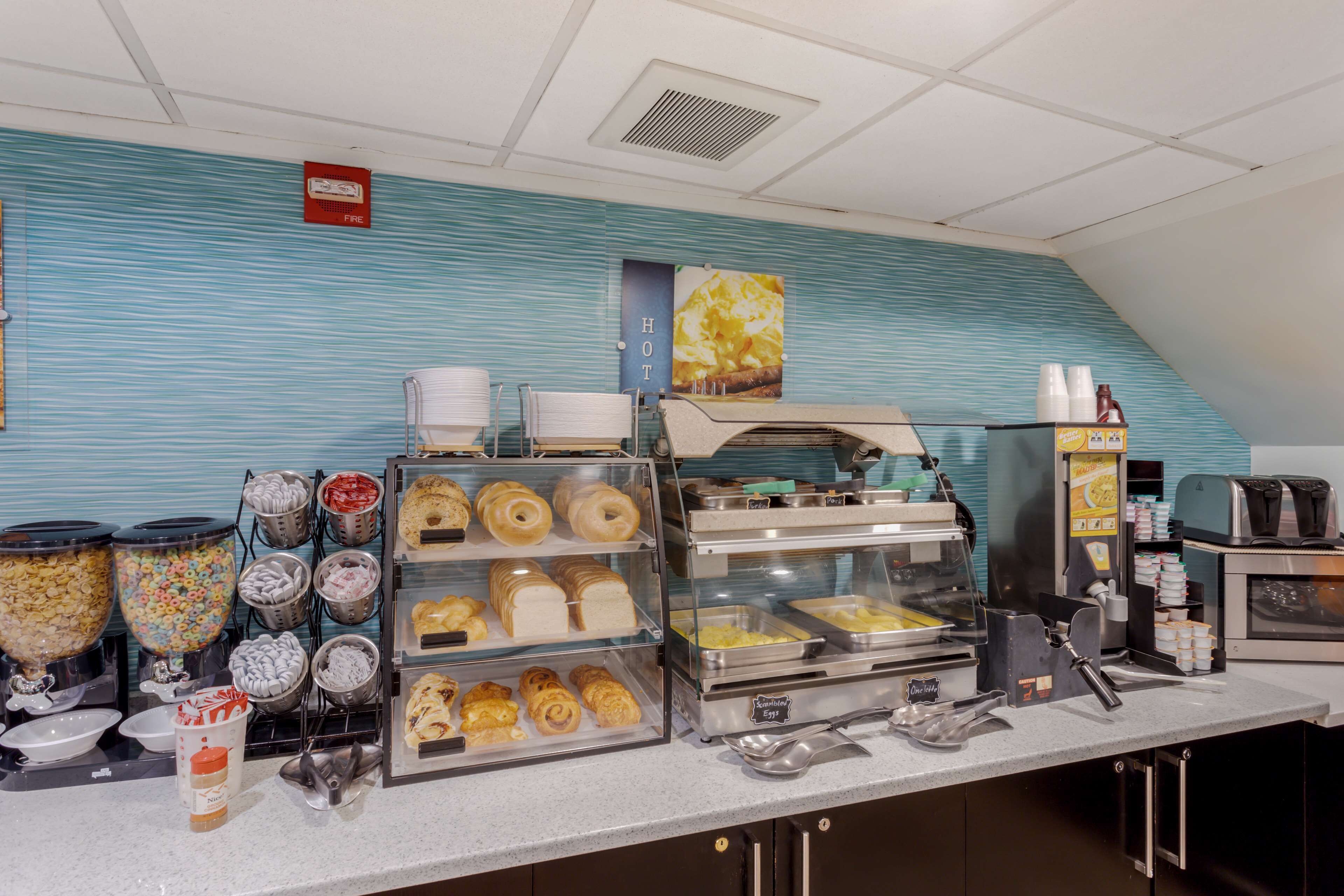 A breakfast buffet with various food items and a coffee machine.