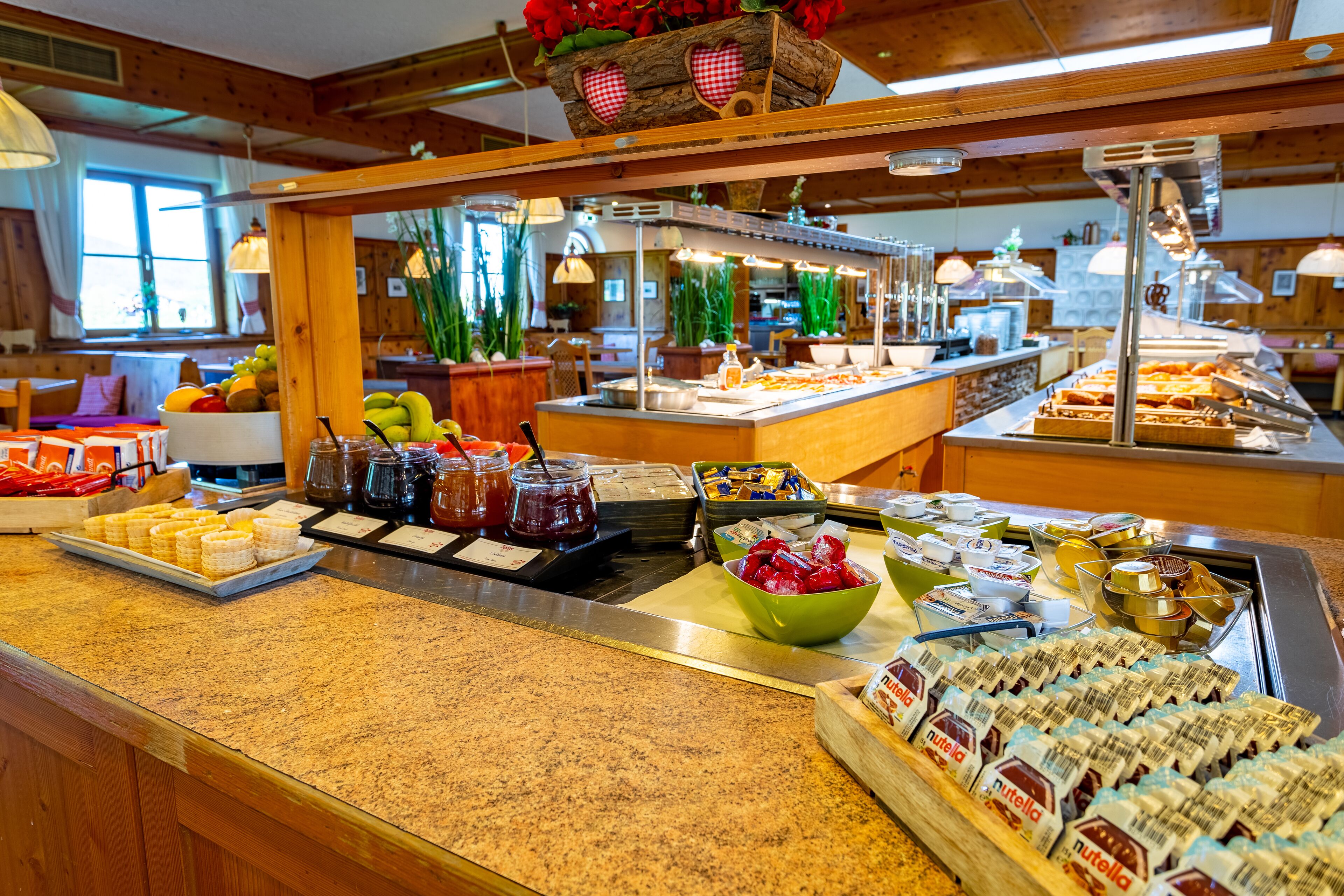 A buffet with various food items and condiments.